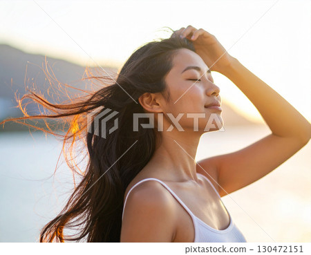 Young woman blown by sea breeze 130472151