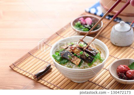 Savory mackerel chazuke: A classic Japanese dish of rice topped with grilled mackerel jerky and hot tea poured over it. 130472173