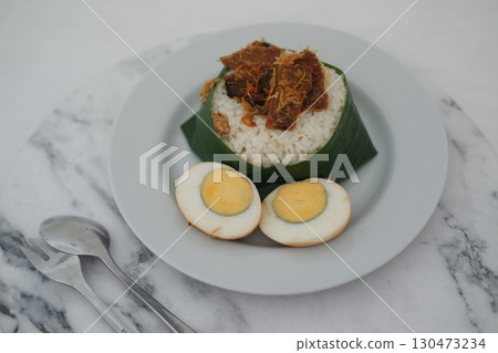 Nasi Lemak with Egg and Fried Crispy Rendang Beef on a Plate Nasi Lemak with Egg and Fried Crispy Rendang Beef on a Plate 130473234