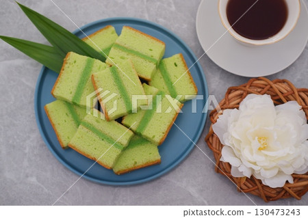 Delicious Pandan Layer Cake Slices on a Blue Plate 130473243