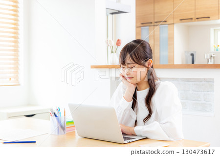 Young woman working remotely Young woman working remotely 130473617