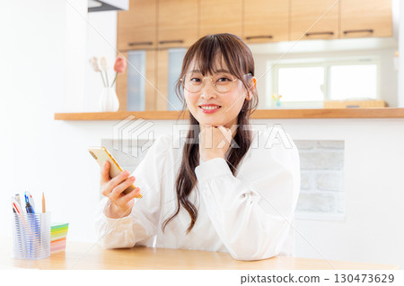 A woman using a smartphone A woman using a smartphone 130473629