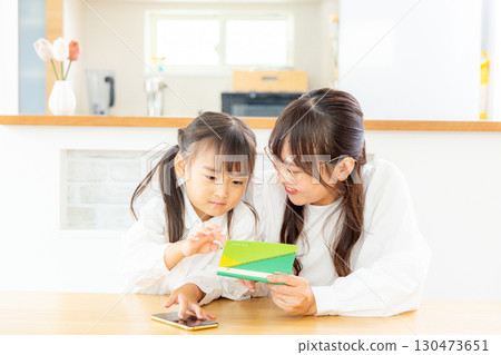 母親與孩子一起看存摺 130473651