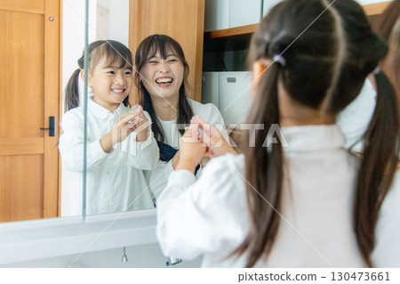 Parent and child washing hands in the washroom 130473661