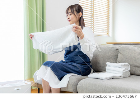 A woman folding laundry 130473667