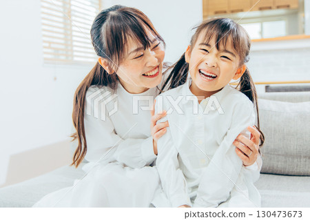 Parents and children relaxing in the living room Parents and children relaxing in the living room 130473673