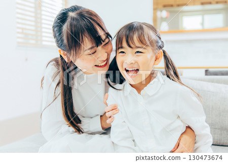 Parents and children relaxing in the living room 130473674