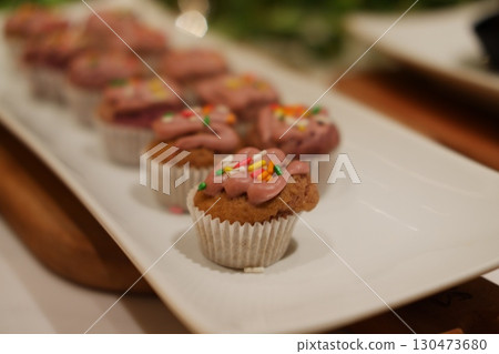 Mini Cupcakes with Pink Frosting and Sprinkles on a White Platter Mini Cupcakes with Pink Frosting and Sprinkles on a White Platter 130473680