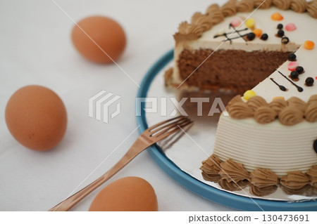 Chocolate cake with decorative frosting and eggs on a plate Chocolate cake with decorative frosting and eggs on a plate 130473691