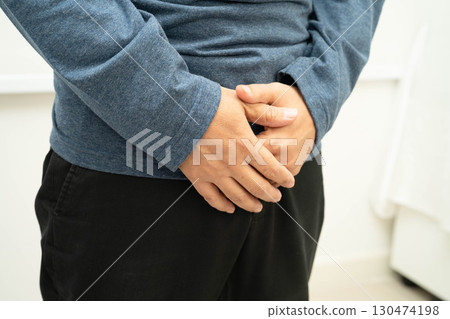 Hernia, Asian man stomach ache, abdominal pain and urology problem health. 130474198