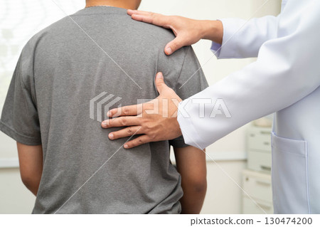 Physical therapy, Asian therapist doctor treat perform pain young man in hospital. Physical therapy, Asian therapist doctor treat perform pain young man in hospital. 130474200