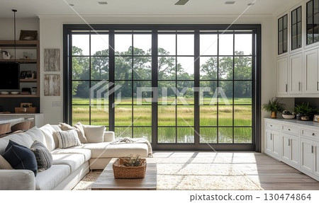 Modern living room with large windows and scenic view 130474864