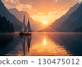 A Sailboat Is Sailing Along The Ocean Against A Colorful Sunset Sky 130475012
