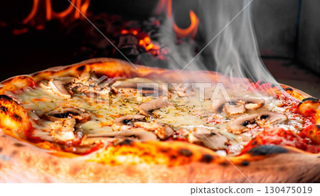 macro photo of pizza in a wood-fired oven with light smoke 130475019