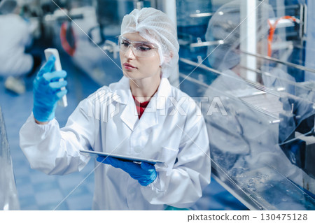 Industry inspector team working, QC staff work checking machine operation for safety and hygiene in drink factory 130475128