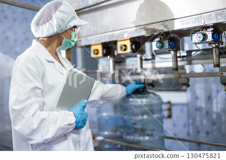 Industry inspector team working, QC staff work checking machine operation for safety and hygiene in drink factory 130475821