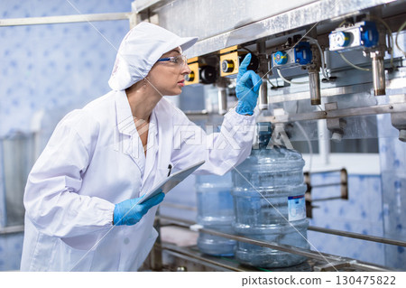 Industry inspector team working, QC staff work checking machine operation for safety and hygiene in drink factory 130475822