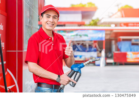 Happy gas station staff worker hand holding fuel nozzle for refill car fuel, Petroleum business Happy gas station staff worker hand holding fuel nozzle for refill car fuel, Petroleum business 130475849