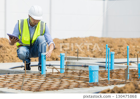 Asian construction engineer, Japanese builder worker male working inspecting footing house building. 130475868