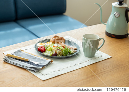 Breakfast: Bread and salad on the table 130476456