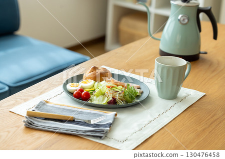 Breakfast: Bread and salad on the table 130476458