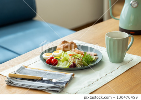 Breakfast: Bread and salad on the table 130476459