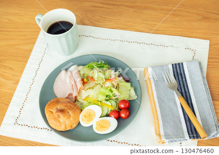 Breakfast: Bread and salad on the table 130476460
