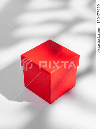 Red box on a white background with soft shadows. Concept of a gift for a holiday 130477059