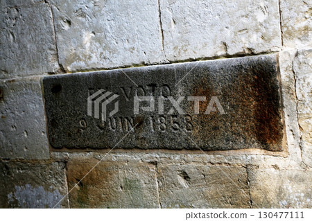 Historical inscription located on a weathered stone wall from 1858 in an old building Historical inscription located on a weathered stone wall from 1858 in an old building 130477111