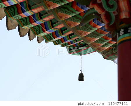 Colorful traditional architecture with bell at temple against clear blue sky Colorful traditional architecture with bell at temple against clear blue sky 130477121