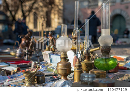 Vintage collectibles displayed at a market in a charming outdoor setting during a sunny day 130477129