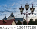 Historic church building with domed roof against clear blue sky in a vibrant town 130477180