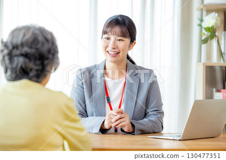 Businesswoman working with elderly people Businesswoman working with elderly people 130477351