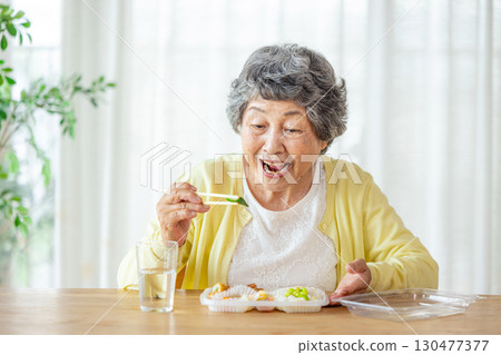 Senior woman to eat Senior woman to eat 130477377