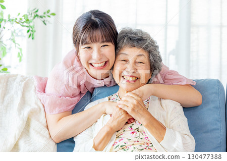 Grandmother and grandson standing close together 130477388