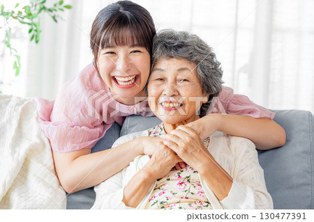 Grandmother and grandson standing close together 130477391