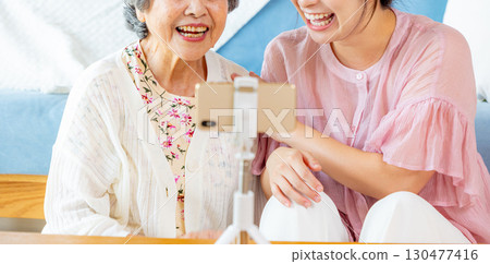Seniors and grandchildren broadcasting Seniors and grandchildren broadcasting 130477416