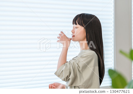 Sick woman taking oral medication, supplements, medicines, medication Sick woman taking oral medication, supplements, medicines, medication 130477621