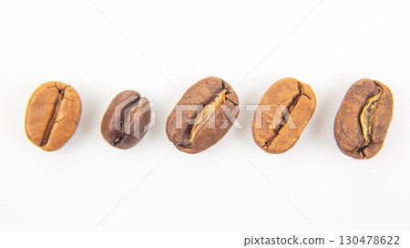 Different varieties of coffee beans showcasing unique colors and textures on white background Different varieties of coffee beans showcasing unique colors and textures on white background 130478622