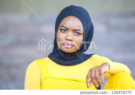 portrait of a young African girl in yellow 130478775