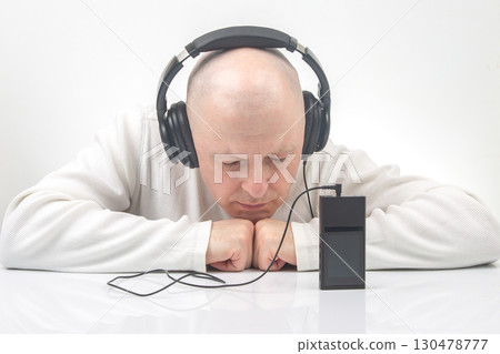 Listening to music with headphones in a serene setting during a quiet afternoon Listening to music with headphones in a serene setting during a quiet afternoon 130478777