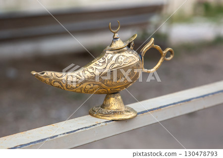 Ornate brass lamp on a railing in Turkey showcasing traditional craftsmanship Ornate brass lamp on a railing in Turkey showcasing traditional craftsmanship 130478793