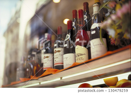 A street corner in Paris: Wines displayed in a wine shop window and reflections A street corner in Paris: Wines displayed in a wine shop window and reflections 130479259