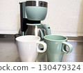 White and green coffee cups and coffee maker 130479324