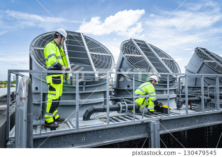 Professional engineer team service checking HVAC cooling tower, fan water Industry air conditioner 130479545