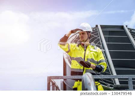 Professional worker servicing HVAC building cooling tower, Industry air conditioner service 130479546