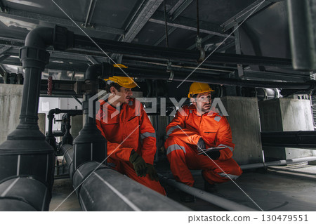 Two professional engineer male teamwork service maintenance, Worker industry water pipe tube system Two professional engineer male teamwork service maintenance, Worker industry water pipe tube system 130479551
