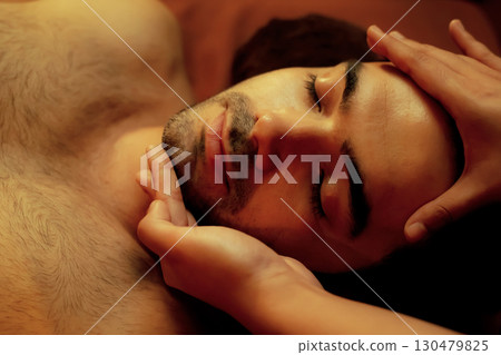 Caucasian man enjoying relaxing anti-stress head massage. Quiescent 130479825