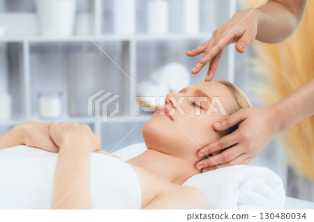 Caucasian woman enjoying relaxing anti-stress head massage. Quiescent Caucasian woman enjoying relaxing anti-stress head massage. Quiescent 130480034