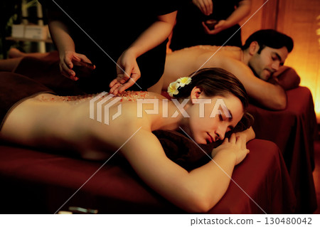 Couple customer having exfoliation treatment in luxury spa. Quiescent Couple customer having exfoliation treatment in luxury spa. Quiescent 130480042